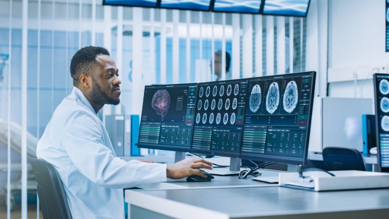 Medical Scientist Working with CT Brain Scan Images on a Persona